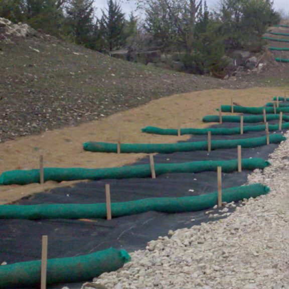 Installing Siltsoxx perpendicular on a disturbed slope to prevent erosion and runoff.
