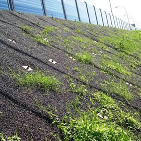 Maccaferri MacMat on slope providing ground stabilization and supporting vegetative growth.
