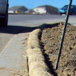 Aspen erosion control wattle lining roadway to prevent erosion.