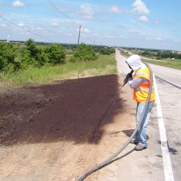 Using hydro mulch on roadside to establish vegetation quickly and prevent erosion.