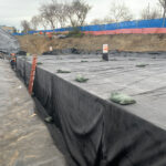 Installing subsurface drainage for slopes around existing utilities.