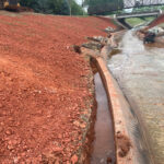 Installing hard armor along channel for stabilization.
