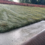 Vegetated hydroturf lining channel for high-flow erosion control.
