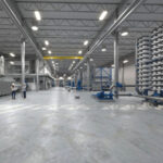 Engineers reviewing plans in large facility.