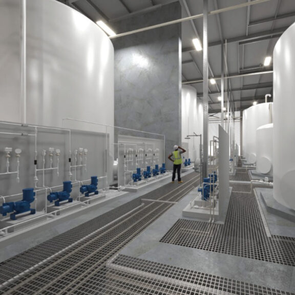 Facility with pipes and worker inspecting operations.