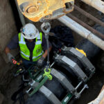 Installing and securing large underground pipes.