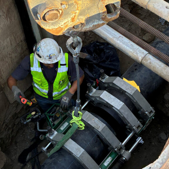 Installing and securing large underground pipes.