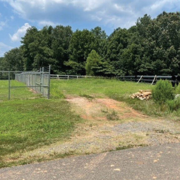 Fenced in grassy area on a job site.