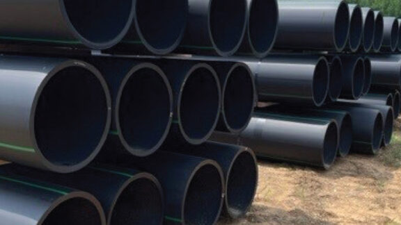 Stacked black pipe for water and sewer infrastructure.