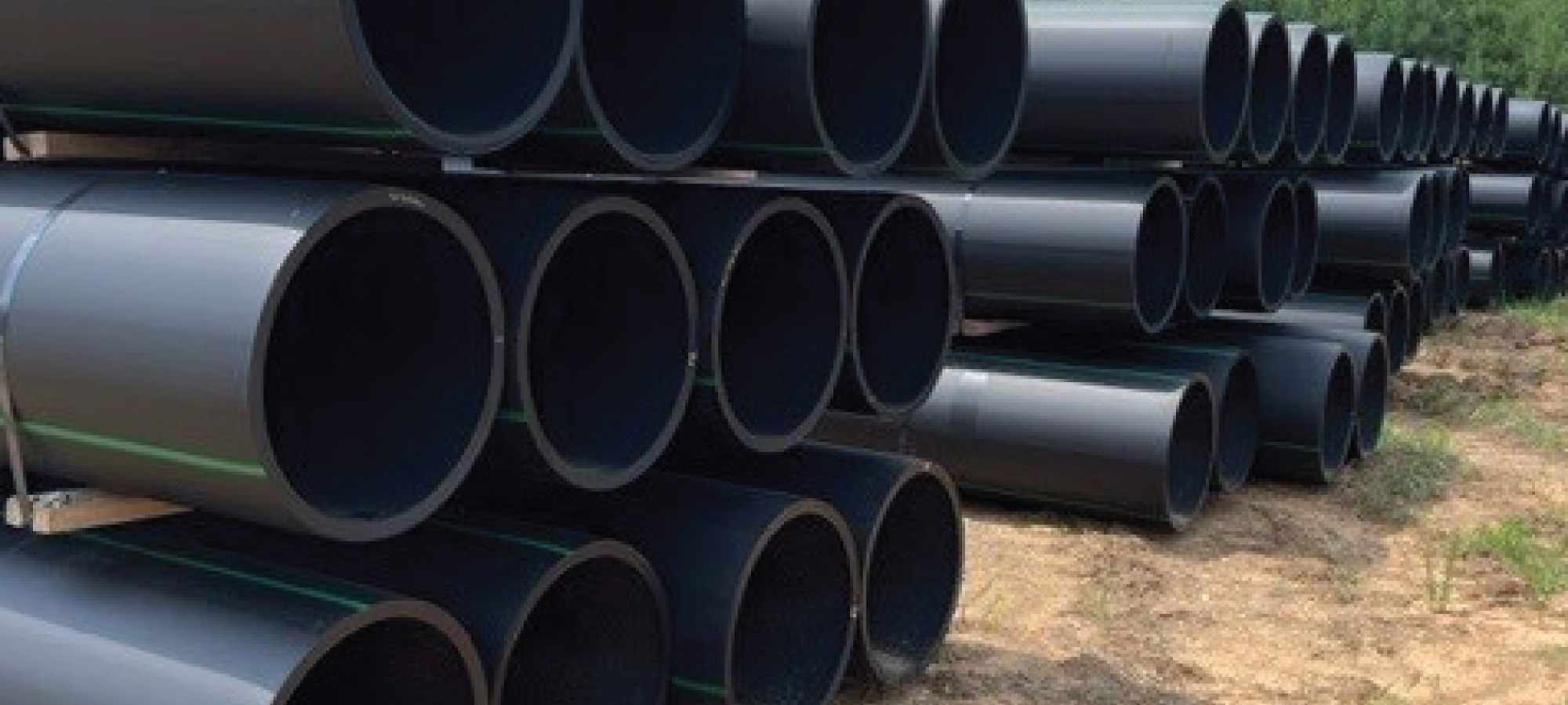 Stacked black pipe for water and sewer infrastructure.