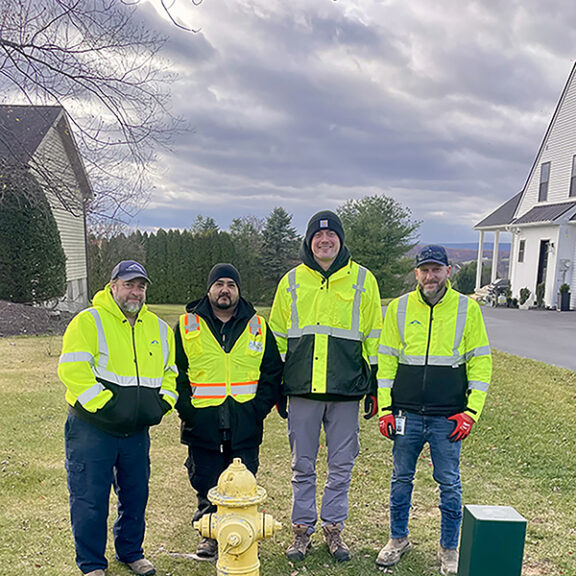 A utility crew wearing yellow safety vests.