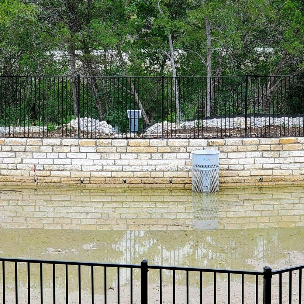 Inlet riser screen in shallow water retention area.