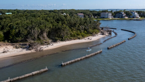 Natrx ExoForms installed along a shoreline with paddle boarder.