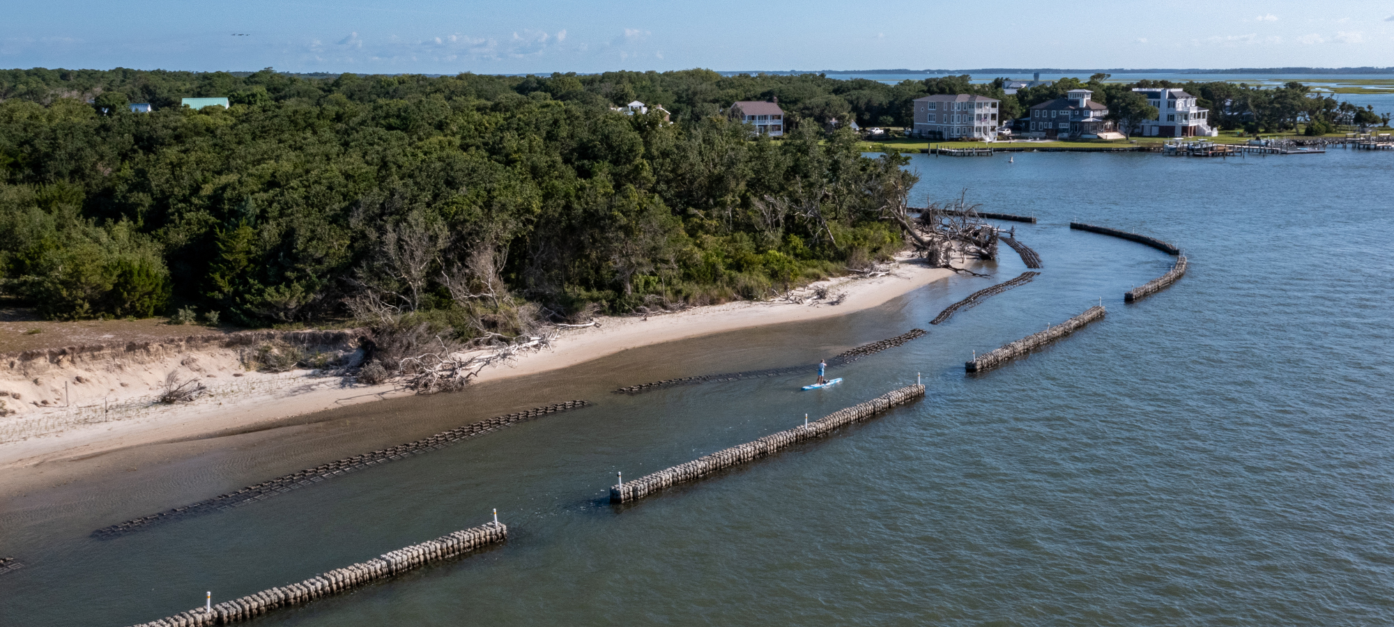 Natrx ExoForms installed along a shoreline with paddle boarder.