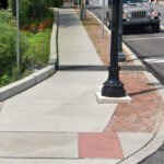 Foxhole Rain Guardian grate across sidewalk