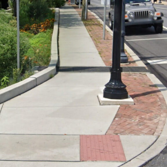 Foxhole Rain Guardian grate across sidewalk
