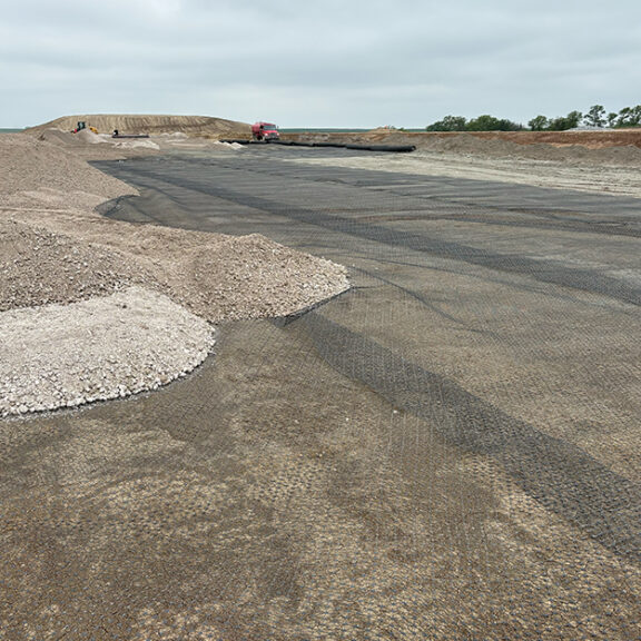 Tensar HX145 laid on top of crushed concrete for stabilization.